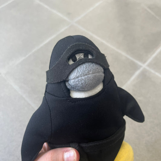 Club Penguin 2009 Series 4 Ninja Penguin Plushie is a black penguin with a black ninja outfit (top+mask) that can be taken off. Released in 2009 by Disney and Jakks Pacific, featuring an embroidered Club Penguin logo on the bottom of the foot. It comes with a Disney-licensed tag.