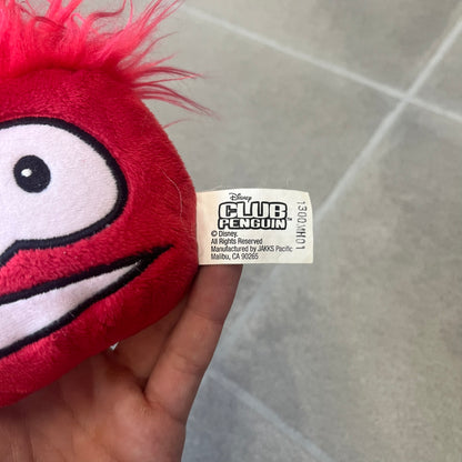 Club Penguin Series 4 Red Puffle Plushie was Released in 2009 by Disney and Jakks Pacific, featuring a smilling embroidered face, troll-like hair and a half plush half beanie body. It comes with a Disney-licensed tag.