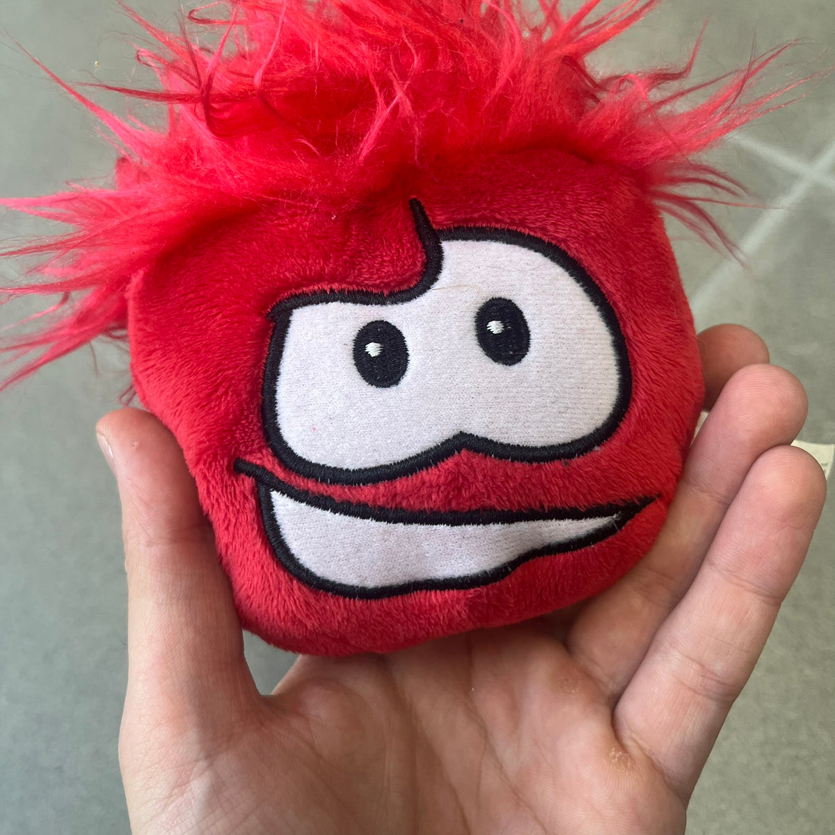 Club Penguin Series 4 Red Puffle Plushie was Released in 2009 by Disney and Jakks Pacific, featuring a smilling embroidered face, troll-like hair and a half plush half beanie body. It comes with a Disney-licensed tag.