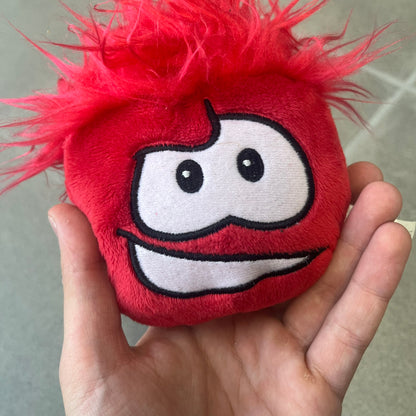 Club Penguin Series 4 Red Puffle Plushie was Released in 2009 by Disney and Jakks Pacific, featuring a smilling embroidered face, troll-like hair and a half plush half beanie body. It comes with a Disney-licensed tag.