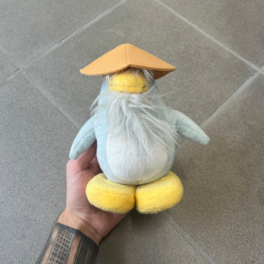 Club Penguin 2009 Series 4 Sensei Penguin Plushie is a gray penguin with a straw hat and long gray beard. Released in 2009 by Disney and Jakks Pacific, featuring an embroidered Club Penguin logo on the bottom of the foot. It comes with a Disney-licensed tag.