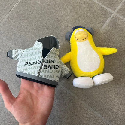 Club Penguin 2010 Series 7 Band Member Penguin Plushie is a yellow penguin with 3D Headphones and a jacket that can be taken off. Released in 2010 by Disney and Jakks Pacific, featuring an embroidered Club Penguin logo on the bottom of the foot. It comes with a Disney-licensed tag.