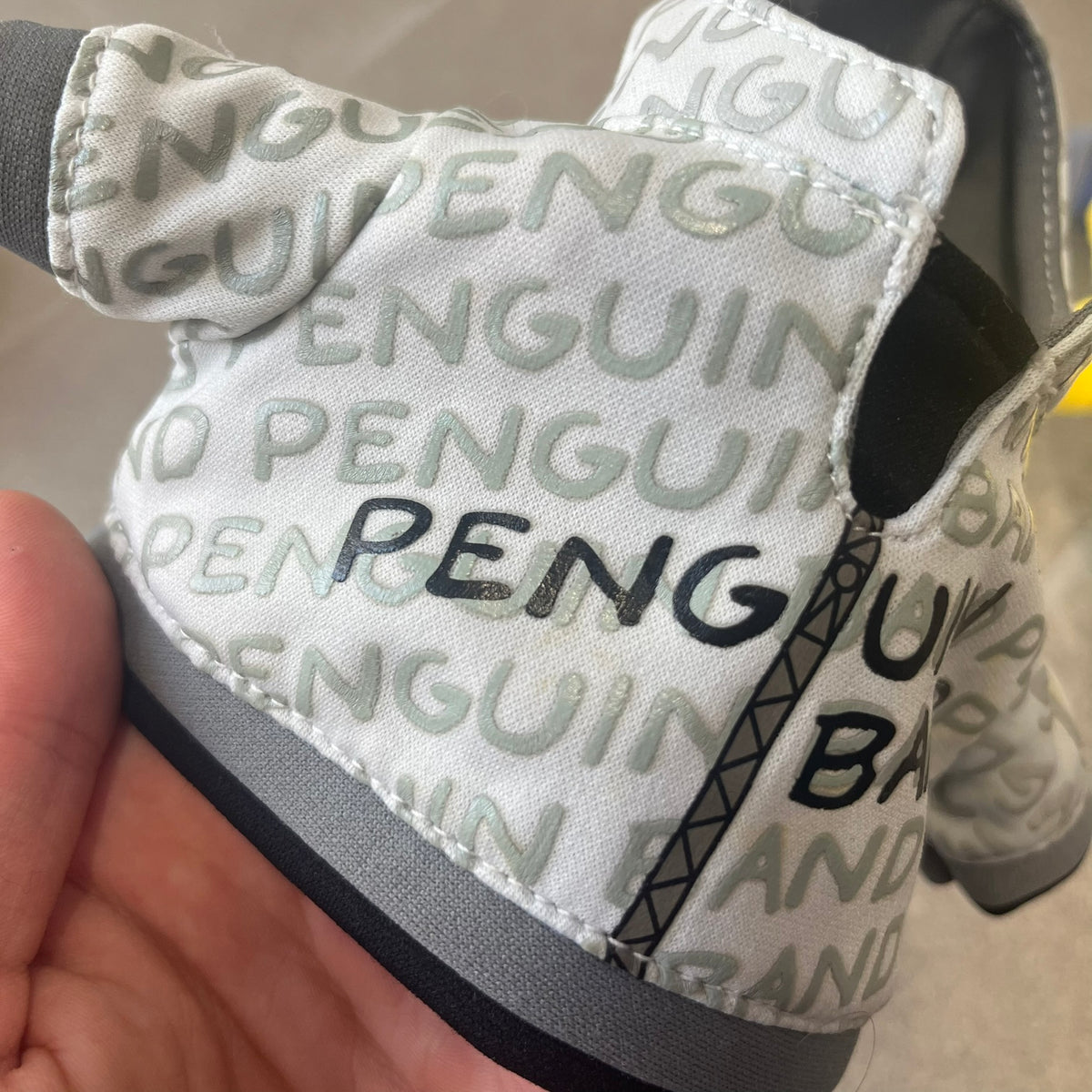 Club Penguin 2010 Series 7 Band Member Penguin Plushie is a yellow penguin with 3D Headphones and a jacket that can be taken off. Released in 2010 by Disney and Jakks Pacific, featuring an embroidered Club Penguin logo on the bottom of the foot. It comes with a Disney-licensed tag.
