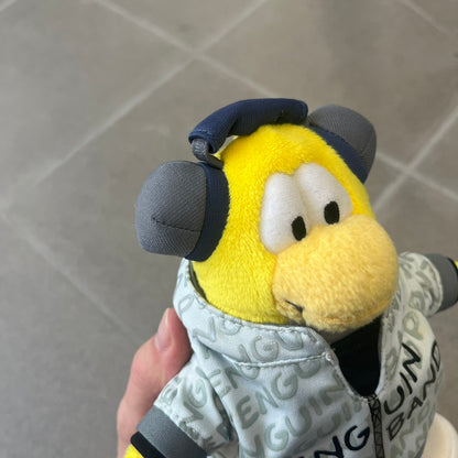 Club Penguin 2010 Series 7 Band Member Penguin Plushie is a yellow penguin with 3D Headphones and a jacket that can be taken off. Released in 2010 by Disney and Jakks Pacific, featuring an embroidered Club Penguin logo on the bottom of the foot. It comes with a Disney-licensed tag.