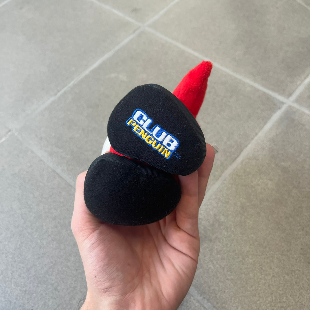 Club Penguin 2010 Series 7 Secret Agent Penguin Plushie is a red penguin with black sunglasses on. He originally had a tuxedo. Released in 2010 by Disney and Jakks Pacific, featuring an embroidered Club Penguin logo on the bottom of the foot. It comes with a Disney-licensed tag.