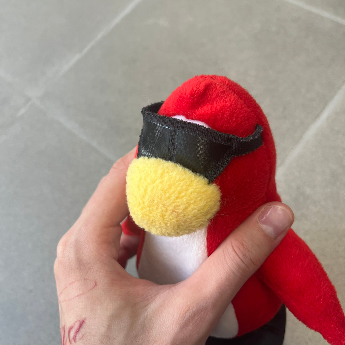 Club Penguin 2010 Series 7 Secret Agent Penguin Plushie is a red penguin with black sunglasses on. He originally had a tuxedo. Released in 2010 by Disney and Jakks Pacific, featuring an embroidered Club Penguin logo on the bottom of the foot. It comes with a Disney-licensed tag.