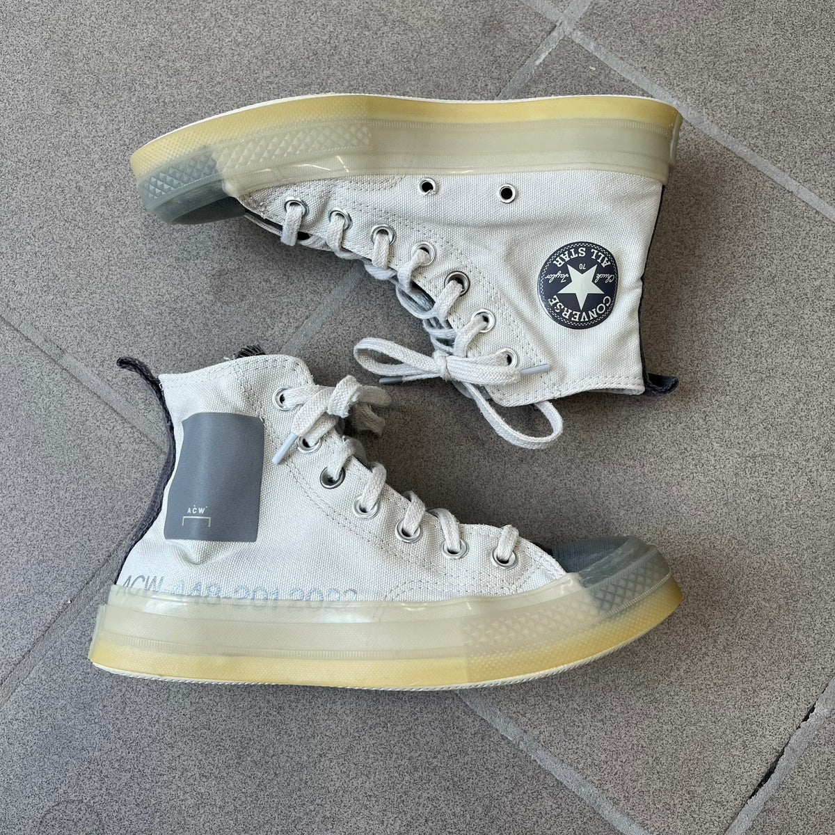 Converse x A-COLD-WALL* Silver Birch Chuck 70 (A02276C) is a limited-edition high-top sneaker from the collaboration with British designer Samuel Ross, released October 6, 2022 in a Silver Birch/Pavement colorway. The canvas upper features a rubber toe cap and a Converse heel plate, with a distinctive translucent, marbled speckled sole.