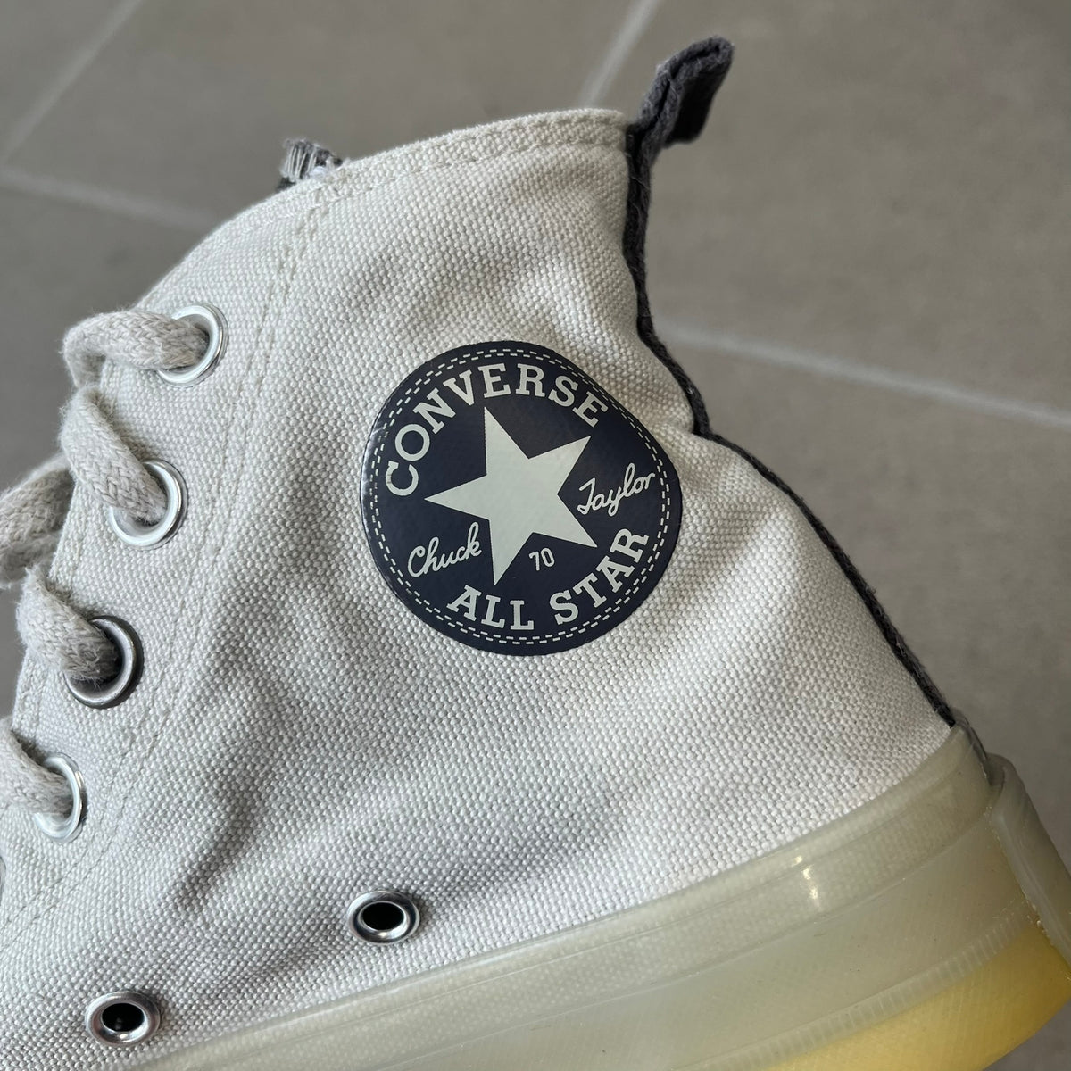 Converse x A-COLD-WALL* Silver Birch Chuck 70 (A02276C) is a limited-edition high-top sneaker from the collaboration with British designer Samuel Ross, released October 6, 2022 in a Silver Birch/Pavement colorway. The canvas upper features a rubber toe cap and a Converse heel plate, with a distinctive translucent, marbled speckled sole.