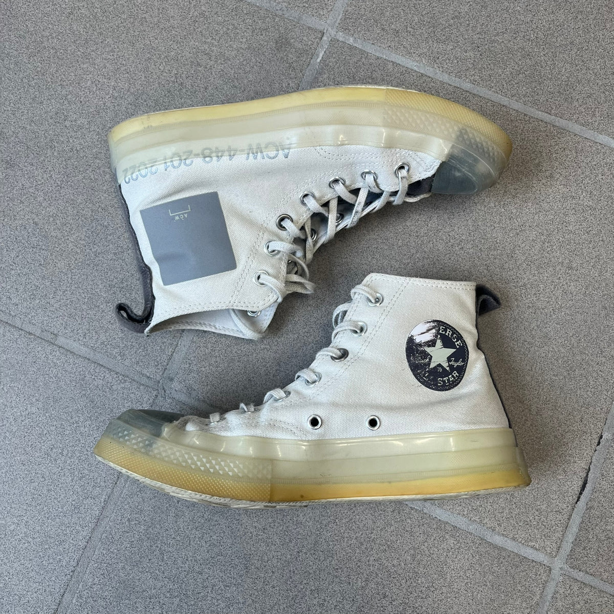 Converse x A-COLD-WALL* Silver Birch Chuck 70 (A02276C) is a limited-edition high-top sneaker from the collaboration with British designer Samuel Ross, released October 6, 2022 in a Silver Birch/Pavement colorway. The canvas upper features a rubber toe cap and a Converse heel plate, with a distinctive translucent, marbled speckled sole.
