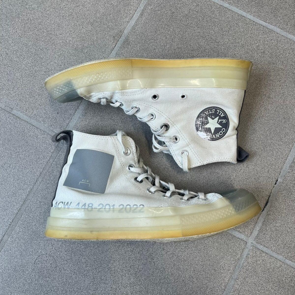 Converse x A-COLD-WALL* Silver Birch Chuck 70 (A02276C) is a limited-edition high-top sneaker from the collaboration with British designer Samuel Ross, released October 6, 2022 in a Silver Birch/Pavement colorway. The canvas upper features a rubber toe cap and a Converse heel plate, with a distinctive translucent, marbled speckled sole.