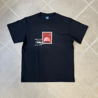 Corteiz x Skepta Konnichiwa 10th Anniversary BlackTee is a 100% cotton T-shirt released to mark the 10th anniversary of Skepta's "Konnichiwa" album, featuring the original album cover artwork with a red postage stamp graphic of Skepta. The design includes a "First Class" ink stamp alongside the Corteiz logo replacing the original cover's "London" mark.