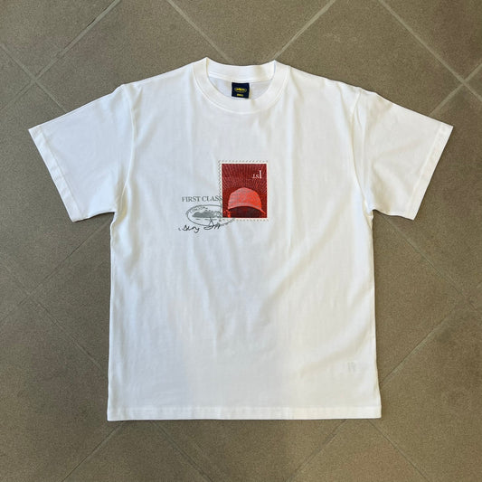 Corteiz x Skepta Konnichiwa 10th Anniversary White Tee is a 100% cotton T-shirt released to mark the 10th anniversary of Skepta's "Konnichiwa" album, featuring the original album cover artwork with a red postage stamp graphic of Skepta. The design includes a "First Class" ink stamp alongside the Corteiz logo replacing the original cover's "London" mark.