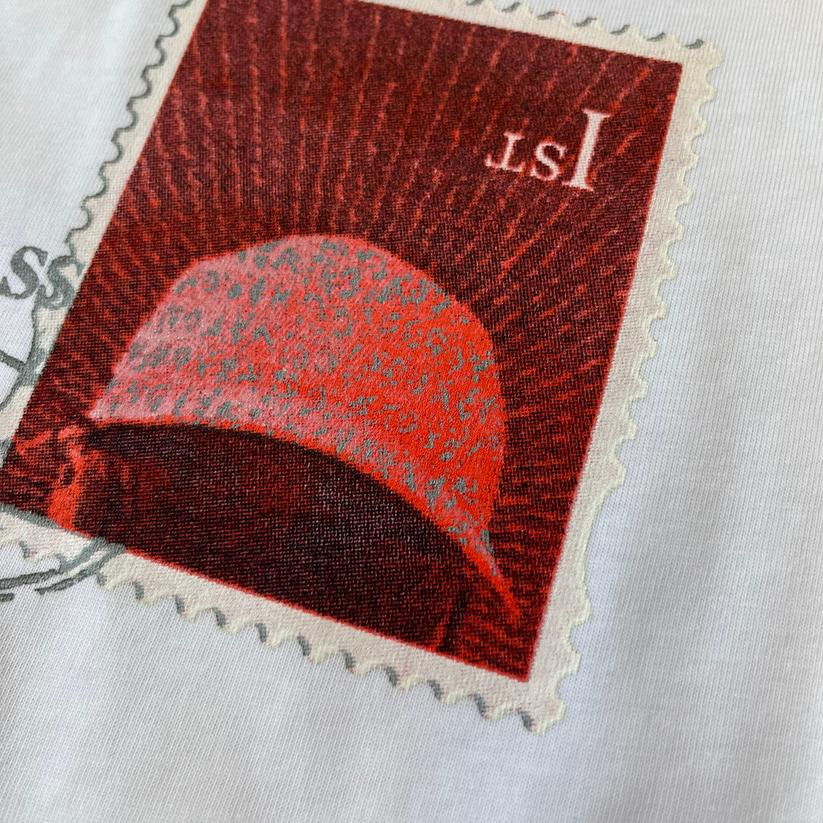 Corteiz x Skepta Konnichiwa 10th Anniversary White Tee is a 100% cotton T-shirt released to mark the 10th anniversary of Skepta's "Konnichiwa" album, featuring the original album cover artwork with a red postage stamp graphic of Skepta. The design includes a "First Class" ink stamp alongside the Corteiz logo replacing the original cover's "London" mark.