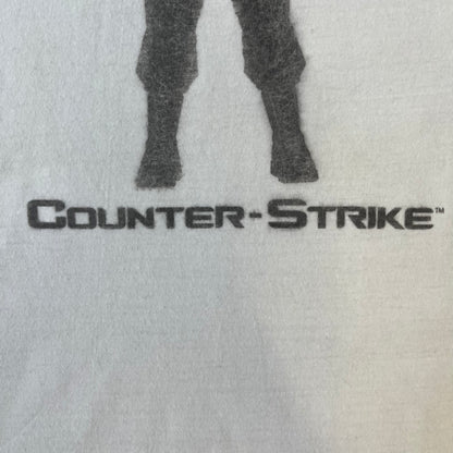 Counter Strike 1.6 Bootleg White Tee is a white, 100% cotton European bootleg made on an "American" blank, featuring a CS 1.6 counter-terrorist model standing with his arms out on the front with "Counter-Strike" text printed below.