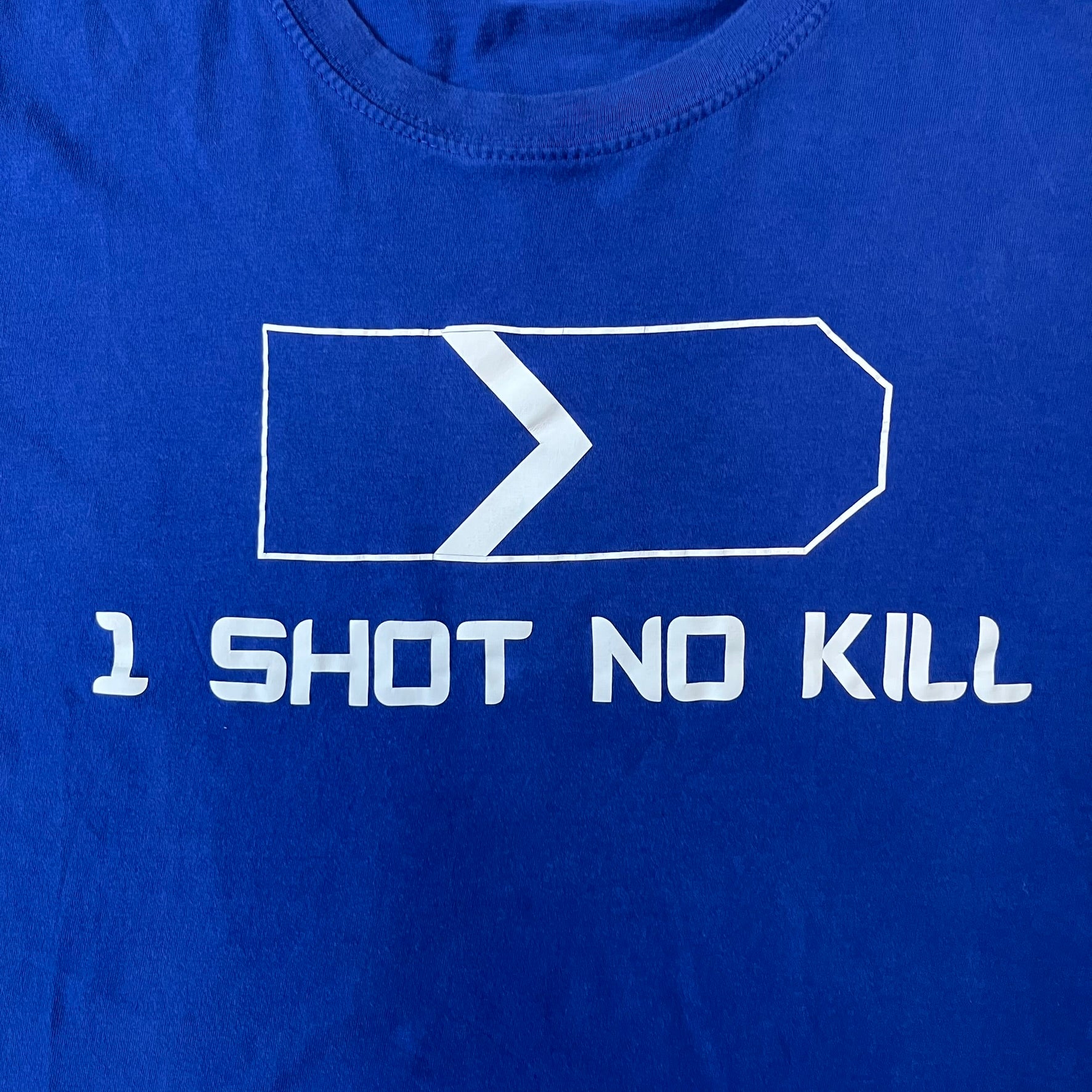Counter Strike “1 Shot No Kill” Blue Tee features a blue T-shirt made on a Piccolio blank. The front has a Counter-Strike Silver 1 rank graphic with a white “1 Shot No Kill” text underneath. This is not an official Valve release.