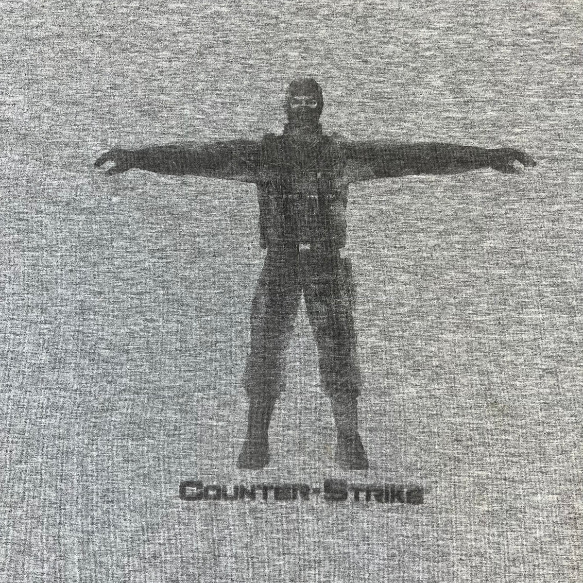 Counter Strike 2000's Bootleg Gray Tee is a gray, 100% cotton European bootleg made in Greece on an "Apple T-Shirt" blank, featuring a CS 1.6 counter-terrorist model T-posing on the front with "Counter-Strike" text printed below.