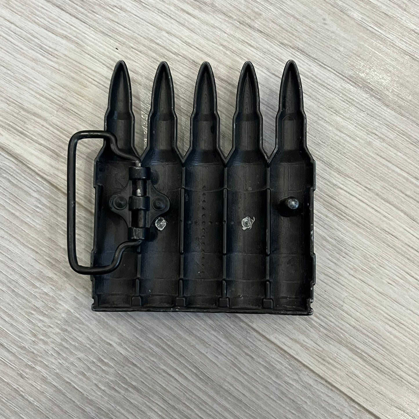 Counter Strike Metal Belt Buckle featuring five metal bullets with black vitreous enamel stripes. Includes a metal dog tag plaque on the front with “Counter Strike” text and the iconic Counter Strike logo of a shooter.