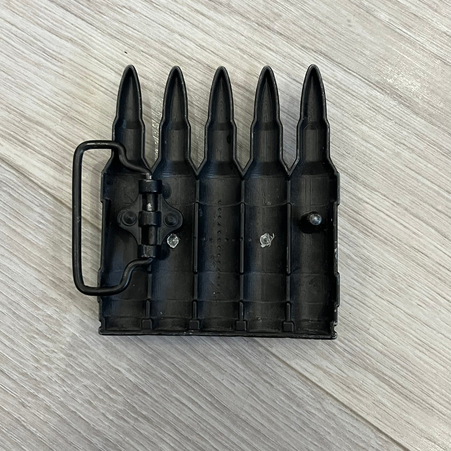 Counter Strike Metal Belt Buckle featuring five metal bullets with black vitreous enamel stripes. Includes a metal dog tag plaque on the front with “Counter Strike” text and the iconic Counter Strike logo of a shooter.