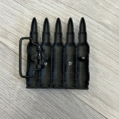 Counter Strike Metal Belt Buckle featuring five metal bullets with black vitreous enamel stripes. Includes a metal dog tag plaque on the front with “Counter Strike” text and the iconic Counter Strike logo of a shooter.