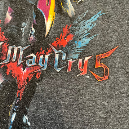 Devil May Cry 5 Promo 2019 Gray Tee is made on a Gildan blank in grey cotton. The front features the Devil May Cry 5 game cover but only with Nero holding his sword, along with large “Devil May Cry 5” text. Made as a promotional T-shirt for the game.