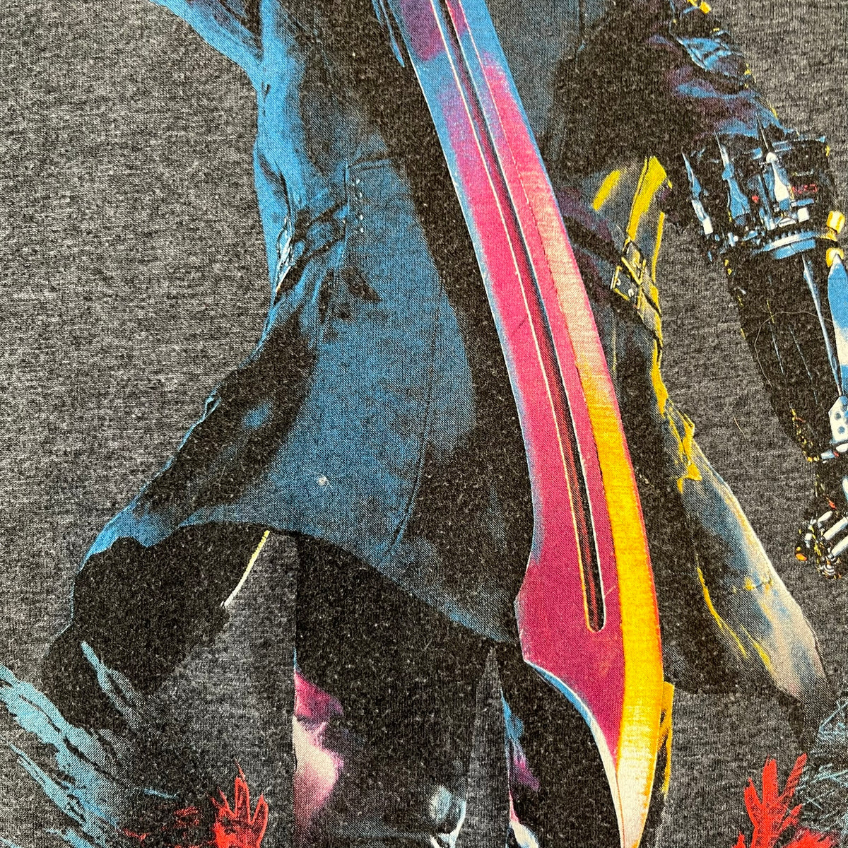 Devil May Cry 5 Promo 2019 Gray Tee is made on a Gildan blank in grey cotton. The front features the Devil May Cry 5 game cover but only with Nero holding his sword, along with large “Devil May Cry 5” text. Made as a promotional T-shirt for the game.