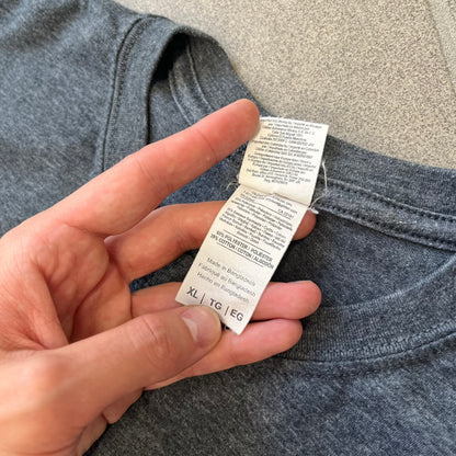 Devil May Cry 5 Promo 2019 Gray Tee is made on a Gildan blank in grey cotton. The front features the Devil May Cry 5 game cover but only with Nero holding his sword, along with large “Devil May Cry 5” text. Made as a promotional T-shirt for the game.