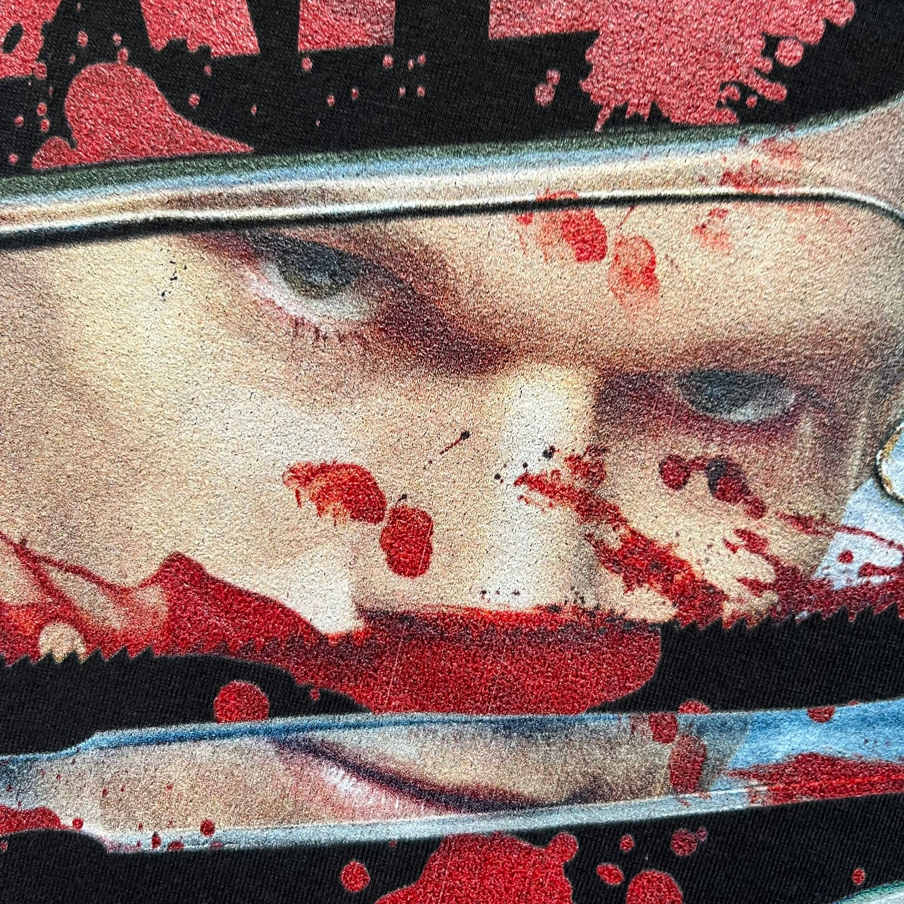 Dexter “Blood Never Lies” 2017 Tee is a black T-shirt featuring a front graphic with red blood-style “Dexter” and “Blood Never Lies” text. Between the texts, the print shows blood-covered tools with Dexter visible in the reflection of a saw. Small 2017 Showtime licensing text appears beneath the graphic, confirming official series merchandise.