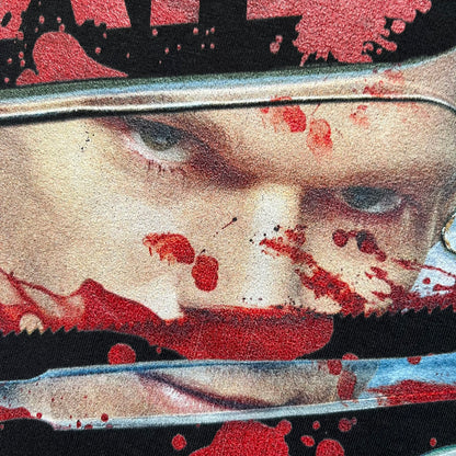 Dexter “Blood Never Lies” 2017 Tee is a black T-shirt featuring a front graphic with red blood-style “Dexter” and “Blood Never Lies” text. Between the texts, the print shows blood-covered tools with Dexter visible in the reflection of a saw. Small 2017 Showtime licensing text appears beneath the graphic, confirming official series merchandise.