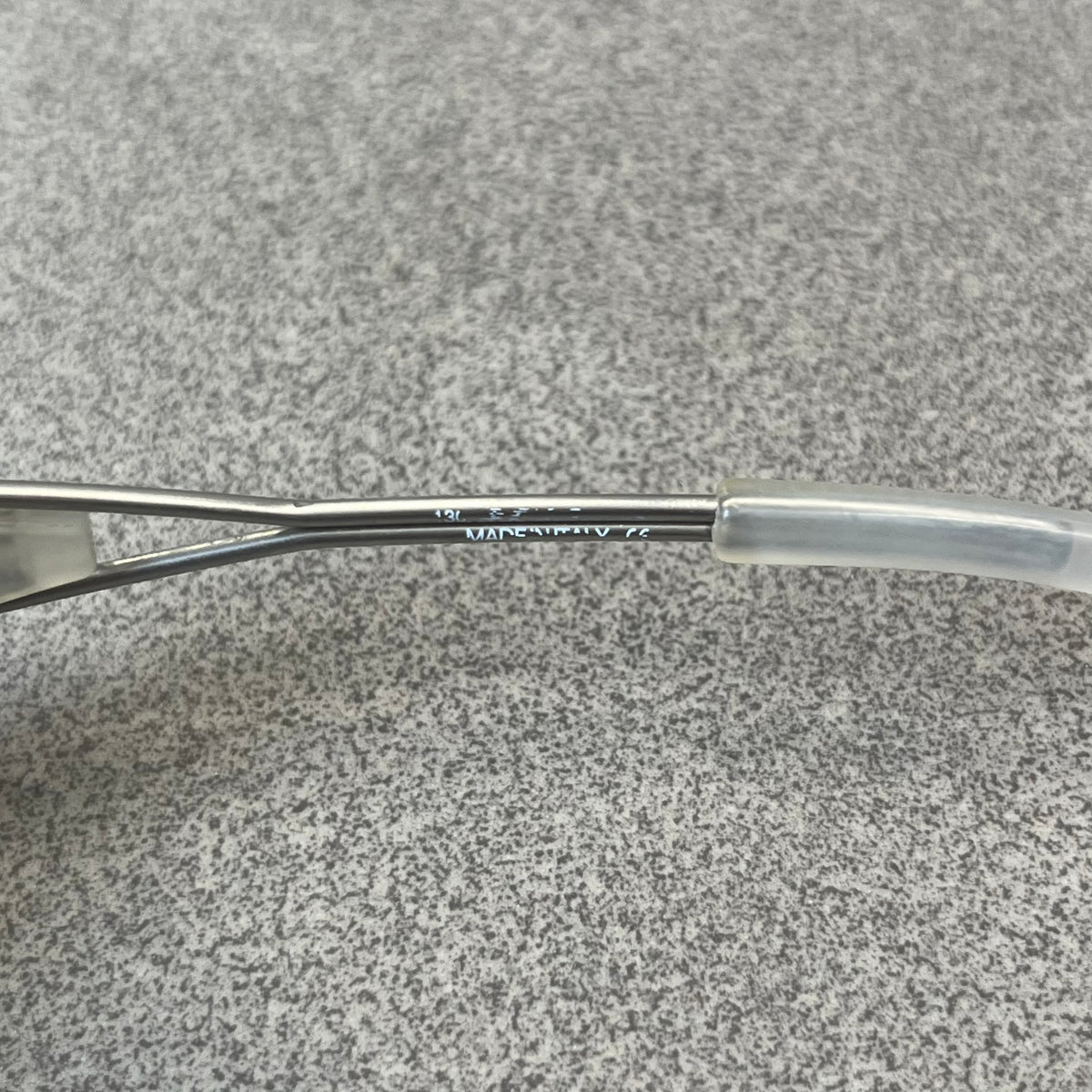 Diesel 2000's Clear Jumbo Sunglasses feature thin silver-tone wire temples with clear plastic sections extending over the ends and front of the frame. The lenses have a grey-tinted transparent finish, with visible screws on the front. A small silver Diesel logo is placed on the side, with white Diesel text printed in the corner of one lens.
