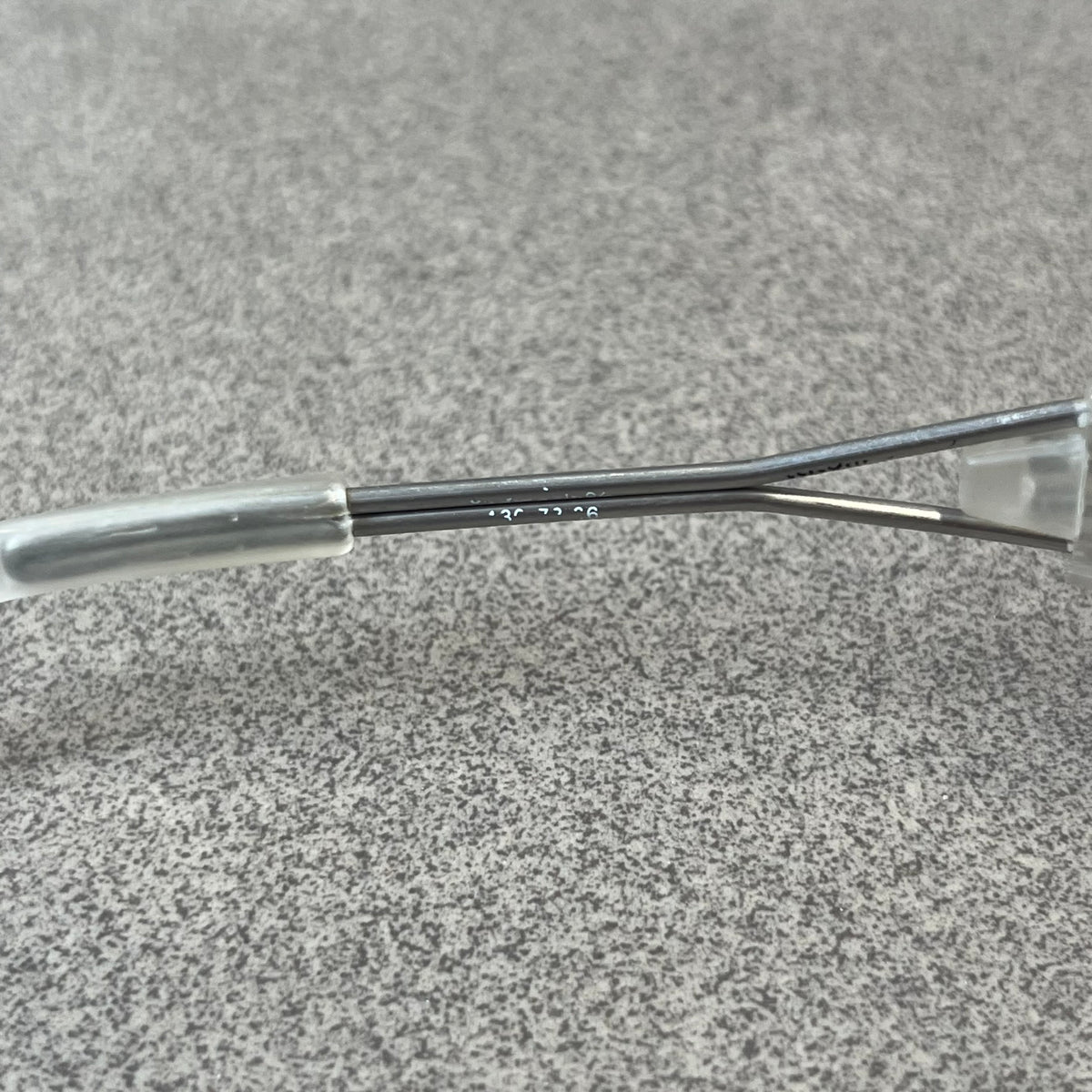 Diesel 2000's Clear Jumbo Sunglasses feature thin silver-tone wire temples with clear plastic sections extending over the ends and front of the frame. The lenses have a grey-tinted transparent finish, with visible screws on the front. A small silver Diesel logo is placed on the side, with white Diesel text printed in the corner of one lens.
