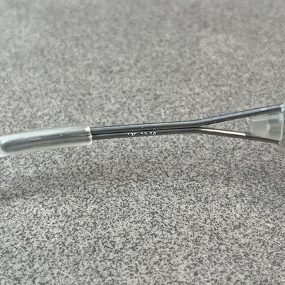 Diesel 2000's Clear Jumbo Sunglasses feature thin silver-tone wire temples with clear plastic sections extending over the ends and front of the frame. The lenses have a grey-tinted transparent finish, with visible screws on the front. A small silver Diesel logo is placed on the side, with white Diesel text printed in the corner of one lens.
