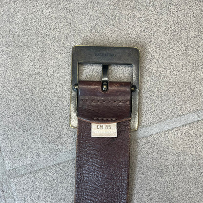 Diesel 2000's Only The Brave Brown Leather Belt features a brown 100% cow leather construction with a bronze-tone buckle. The buckle has engraved Diesel branding, including “Only The Brave Since 1978” text and other details. The belt is marked “Extra Tough,” with gold Diesel text printed on the inside. Made in Italy.
