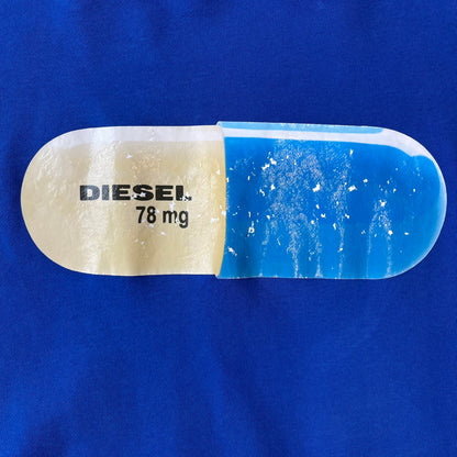 Diesel 2017 "78 mg Pill" Blue Crewneck is a blue, 100% cotton crewneck featuring a large pill graphic in yellow and blue, with black "DIESEL 78 mg" text printed on the yellow half.