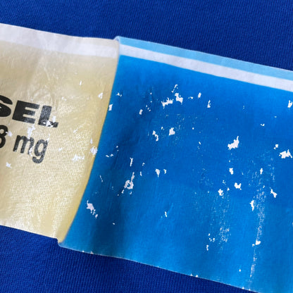 Diesel 2017 "78 mg Pill" Blue Crewneck is a blue, 100% cotton crewneck featuring a large pill graphic in yellow and blue, with black "DIESEL 78 mg" text printed on the yellow half.