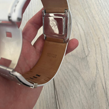 Diesel DZ7054 White Leather Strap Digital Watch features a White leather strap and a black digital display housed in a silver rectangular case. The watch includes a backlight, Arabic numeral indices, and a deployant closure, with a stainless steel case back engraved with Diesel branding and model number DZ-7090. It is water resistant up to 50 meters (5 ATM) and combines industrial design with functional quartz digital movement.&nbsp;