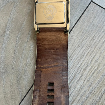 Diesel DZ7068 Studded Leather Strap Digital Watch features a white leather patchwork strap accented with small metal studs and a black digital display housed in a silver rectangular case. The watch includes a backlight, Arabic numeral indices, and a deployant closure, with a stainless steel case back engraved with Diesel branding and model number DZ-7068. It is water resistant up to 50 meters (5 ATM) and combines industrial design with functional quartz digital movement.