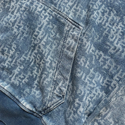 Diesel “Denim” Logo Blue Hoodie is a blue hooded sweatshirt designed with a denim-inspired colorway and washed effect throughout. The fabric features varying light and dark blue shades to mimic the appearance of worn denim, along with an all-over Diesel text pattern in a slightly lighter tone. A small red Diesel patch is placed on the chest, while the cuffs and hem are finished in a contrasting navy color.&nbsp;