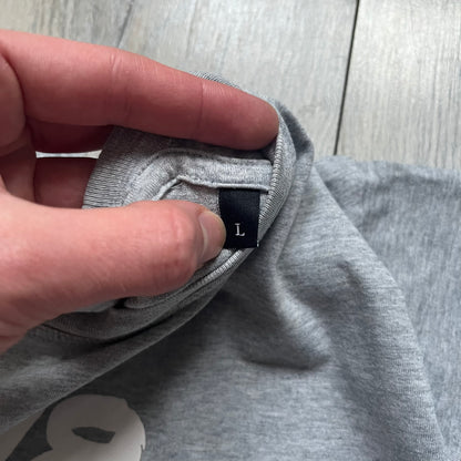 Diesel Music 1978 Gray Tee is a gray T-shirt featuring a large hand-drawn style “Diesel Music 1978” print on the front with additional text below. Made from 100% cotton, it has a crew neckline and short sleeves. The print is white, contrasting with the gray fabric.