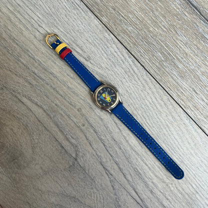Disney Winnie-the-Pooh 1990s Analog Watch features blue leather straps, a gold-tone case, and a navy dial. The dial displays gold hour markers with Winnie the Pooh illustrated in the center. The case back is marked with official Disney licensing and indicates it was made exclusively for Disney. This watch is sized for smaller wrists.
