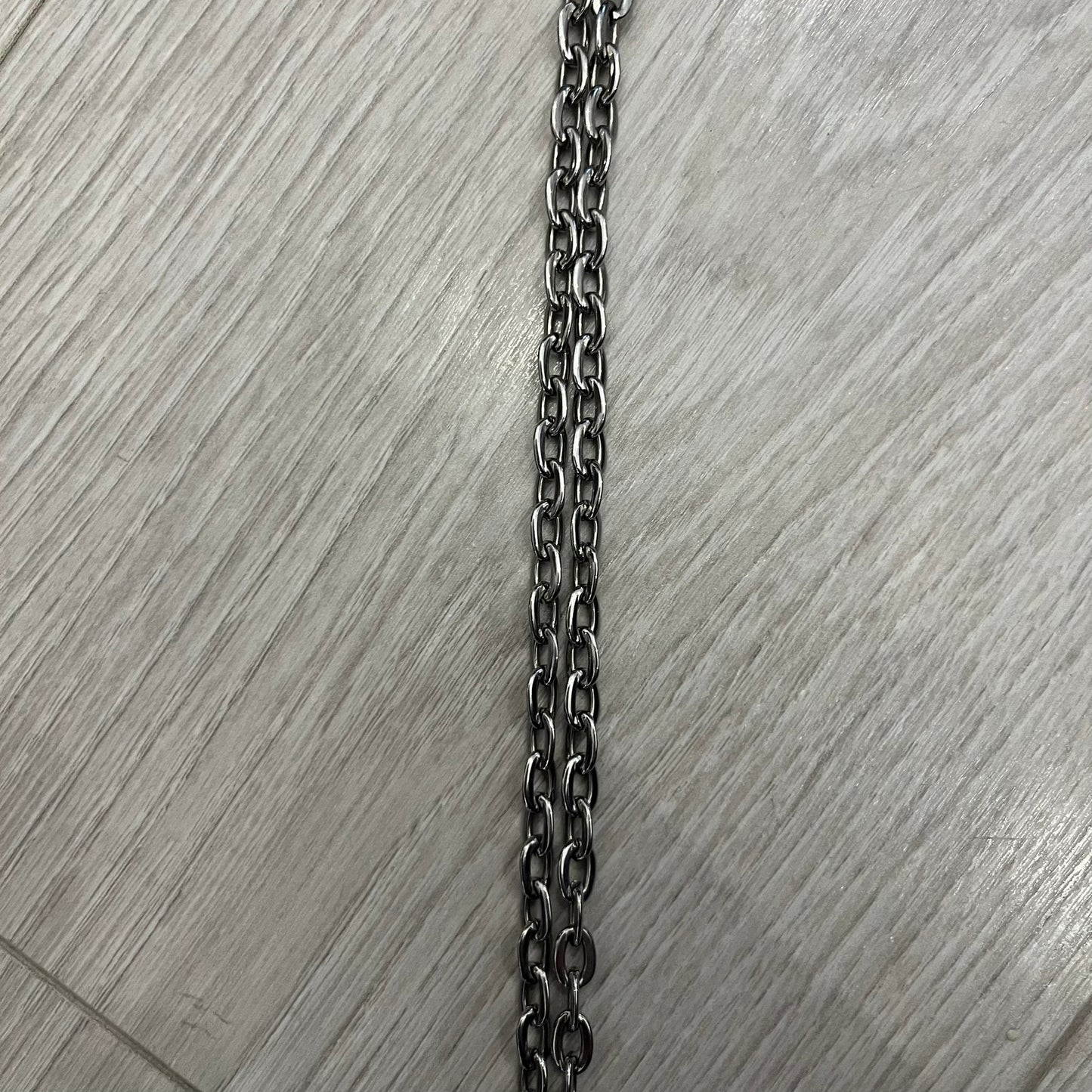 Dolce &amp; Gabbana Propaganda Dog Tag Necklace, featuring a silver stainless steel square tag with four visible screws and the D&amp;G logo engraved on the front. The tag hangs from a durable cable chain, combining sturdy construction with clean, industrial-inspired detailing.