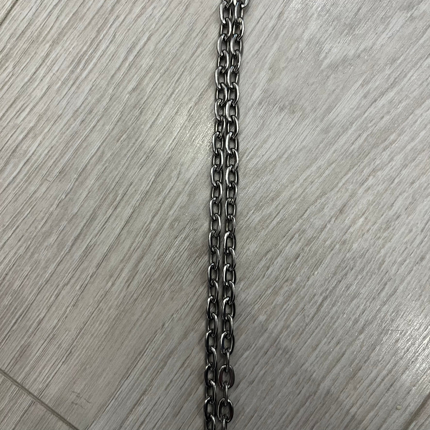 Dolce &amp; Gabbana Propaganda Dog Tag Necklace, featuring a silver stainless steel square tag with four visible screws and the D&amp;G logo engraved on the front. The tag hangs from a durable cable chain, combining sturdy construction with clean, industrial-inspired detailing.