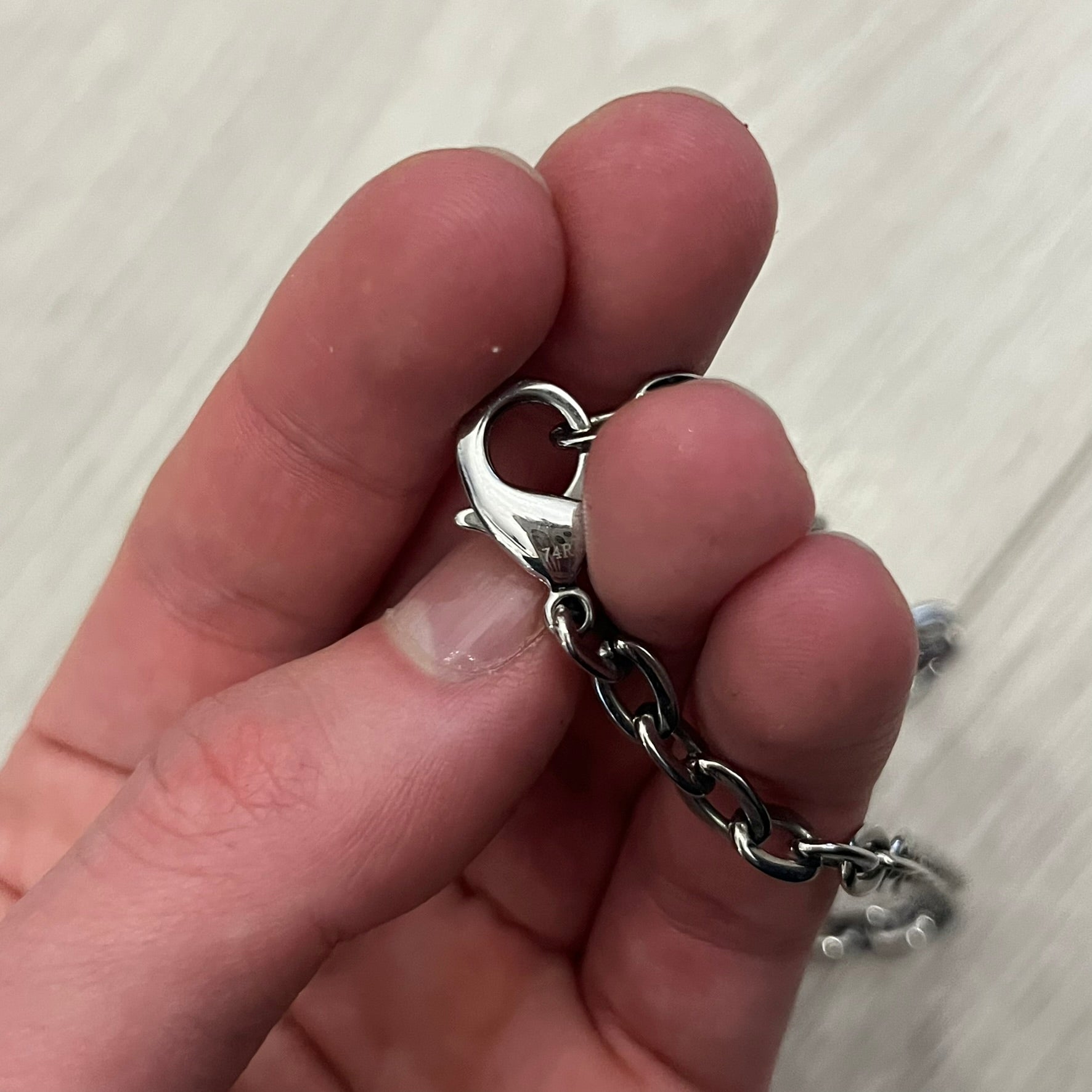 Dolce &amp; Gabbana Propaganda Dog Tag Necklace, featuring a silver stainless steel square tag with four visible screws and the D&amp;G logo engraved on the front. The tag hangs from a durable cable chain, combining sturdy construction with clean, industrial-inspired detailing.