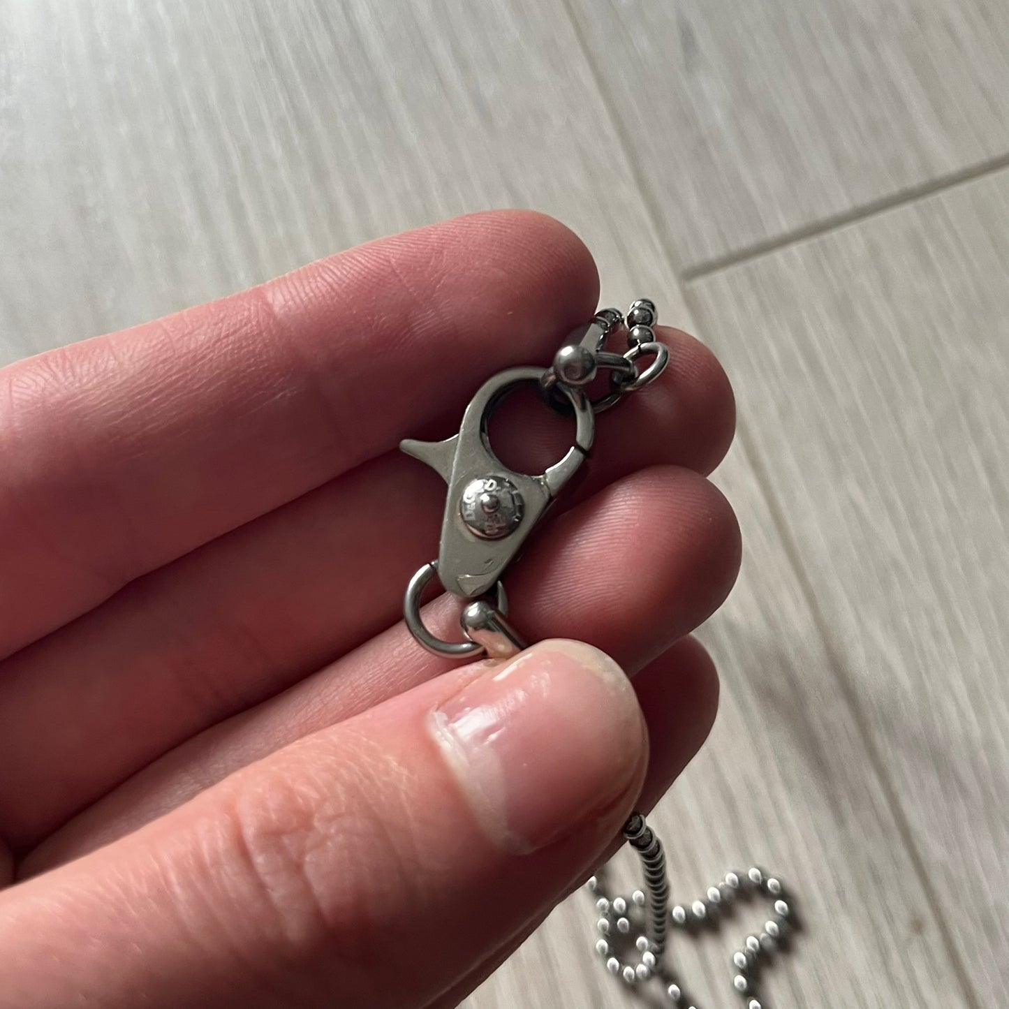 Dolce & Gabbana "I ❤️ D&G" Gold Dog Tag Necklace with a silver stainless steel ball chain, featuring a dog tag engraved with a light "I", a gold metal heart with 3 visible screws, and "D&G" text below, forming the "I ❤️ D&G" design. A playful and collectible vintage piece.