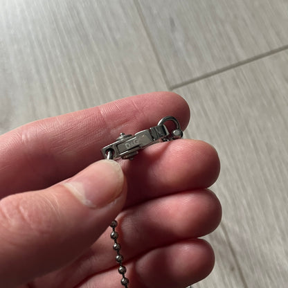 Dolce & Gabbana "I ❤️ D&G" Gold Dog Tag Necklace with a silver stainless steel ball chain, featuring a dog tag engraved with a light "I", a gold metal heart with 3 visible screws, and "D&G" text below, forming the "I ❤️ D&G" design. A playful and collectible vintage piece.