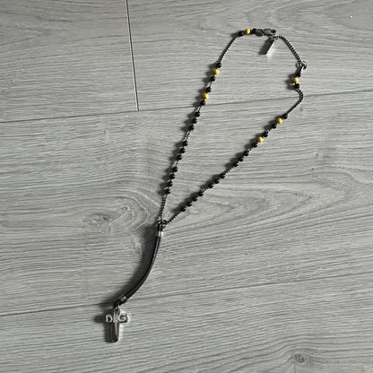 Dolce & Gabbana Pearl Brown Rosary Necklace from the 2000s era. The necklace features a silver-tone metal cross with a D&G logo, connected via a black leather link to a metal chain with alternating brown and yellow pearl-style beads. Rosary-style construction with mixed materials including metal, leather, and resin pearls. Comes complete with the original box.