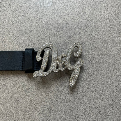 Dolce &amp; Gabbana 2000s Black Crystal Buckle Belt features a black leather strap with a stainless steel D&amp;G logo buckle. The buckle has a decorative italic-style font and is fully covered with crystal/rhinestone detailing on the front. Made in Italy.