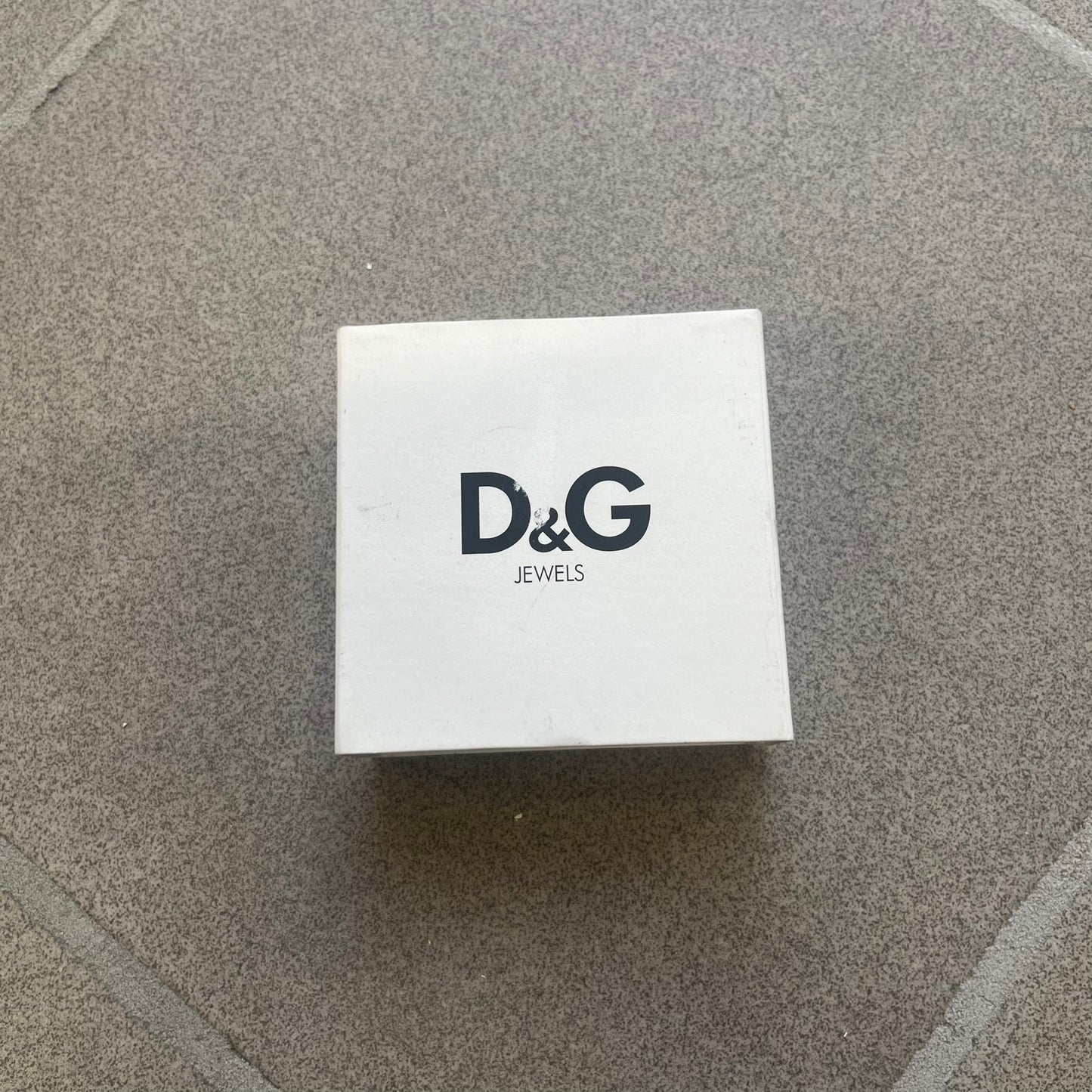 Dolce &amp; Gabbana 2000s Credit Card Necklace (DJ0772) is a rare stainless steel necklace featuring a credit card-shaped pendant. The pendant includes a large raised D&amp;G logo, an engraved D&amp;G logo, and embossed numbers inspired by a real credit card. Finished with a polished metal surface, the necklace comes complete with its original tags and box.