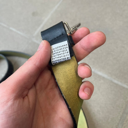 Dolce &amp; Gabbana 2000s Black Crystal Buckle Belt features a black leather strap with a stainless steel D&amp;G logo buckle. The buckle has a decorative italic-style font and is fully covered with crystal/rhinestone detailing on the front. Made in Italy.
