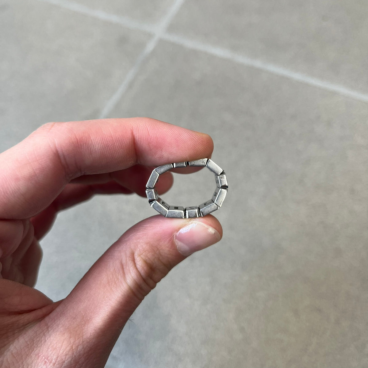Dolce & Gabbana 2000's Crystal Overlap Ring is a stainless steel ring constructed entirely from cutout D&G letters, forming four repeating D&G sets across 12 letters, each covered in crystals. The ring has slight elasticity, with the letters held together internally by strings.