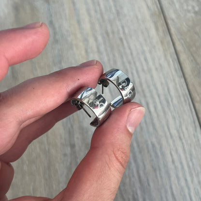 Dolce &amp; Gabbana DJ0404 D&amp;G Logo Earrings are a pair of 2000s silver-tone hoop earrings with a wide profile. The earrings feature an engraved repeating D&amp;G logo around the outer surface. They have a hinged hoop design with a straight post closure and a polished metal finish.